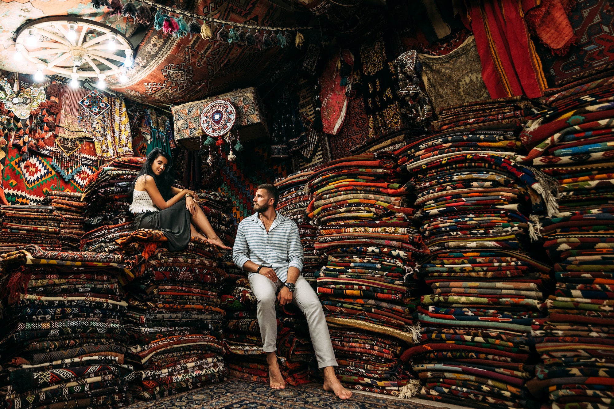 A couple in love travels. Persian shop. Tourists in store. Oriental carpet. Cappadocia. Morocco
