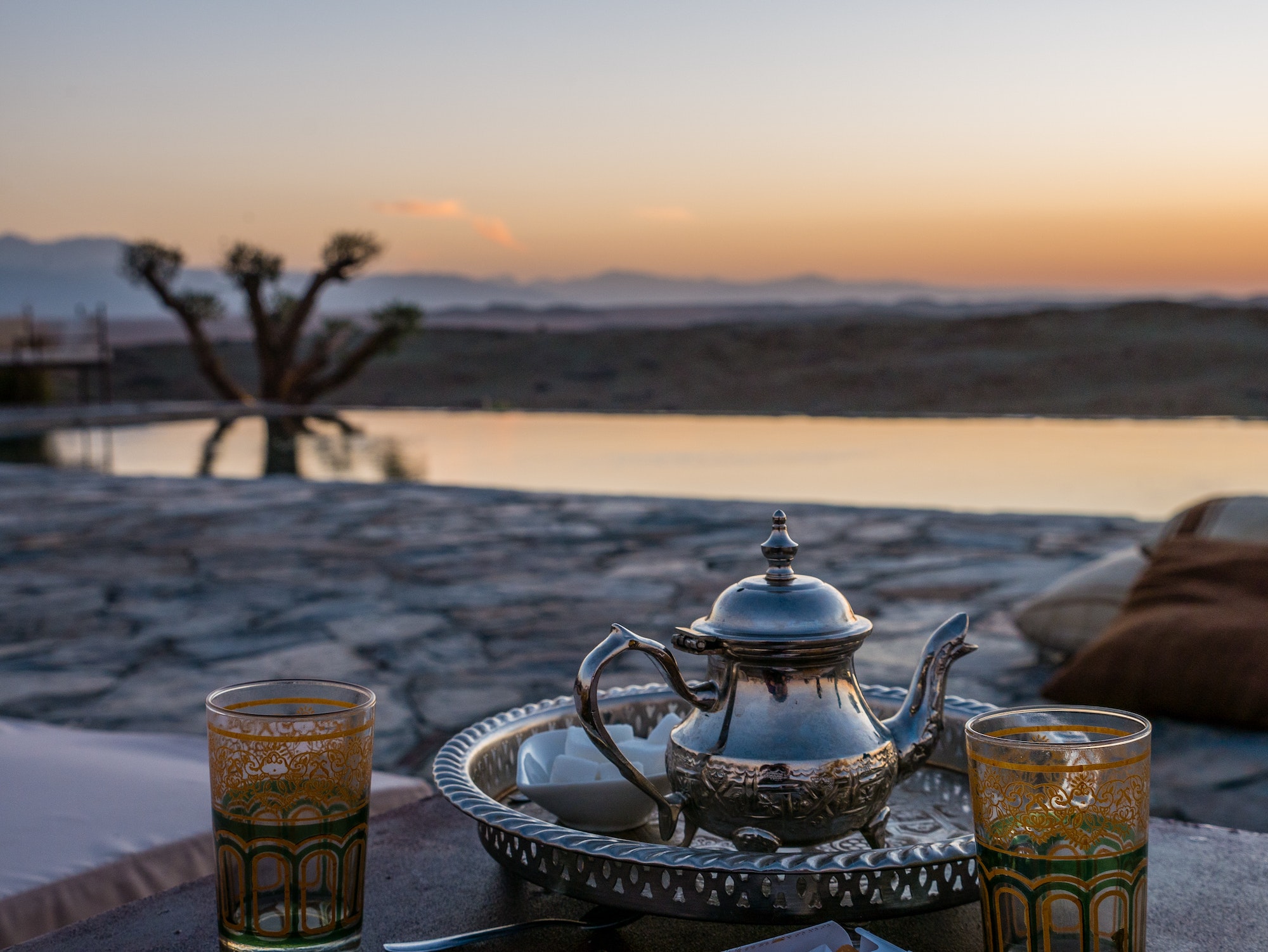 closeup shot of a typical Moroccan mint tea set on the table in Agafay desert, Marrakech