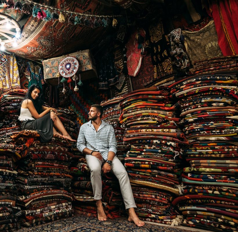 A couple in love travels. Persian shop. Tourists in store. Oriental carpet. Cappadocia. Morocco
