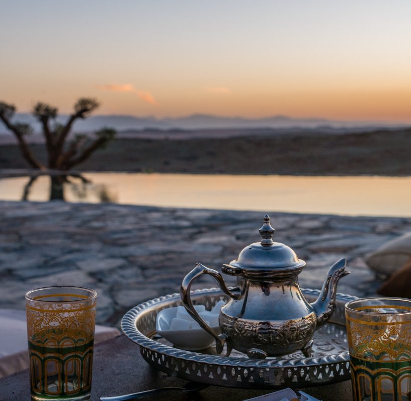 closeup shot of a typical Moroccan mint tea set on the table in Agafay desert, Marrakech